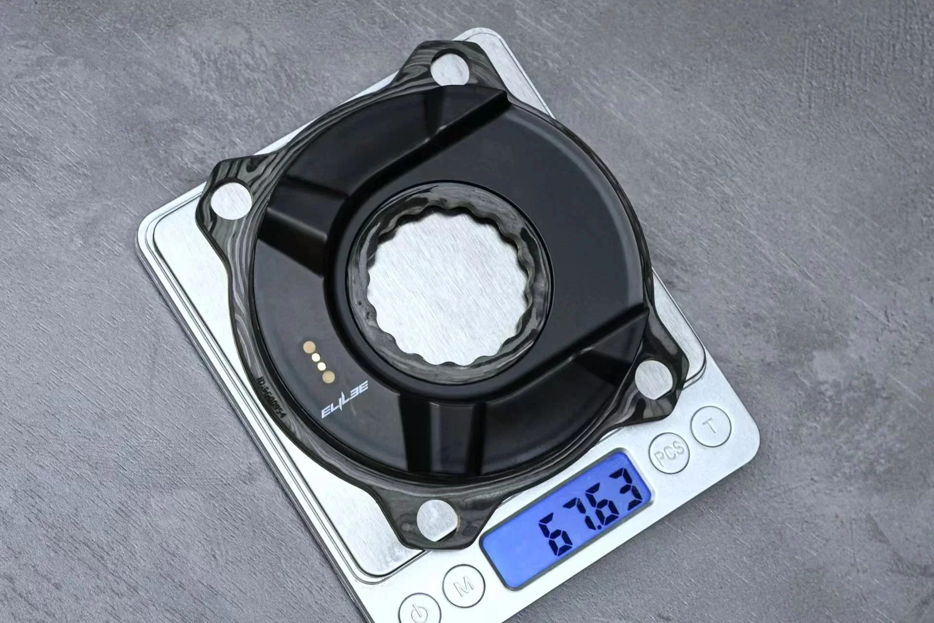 Elilee EK01 carbon version on a digital kitchen scale, reading 67.63 g