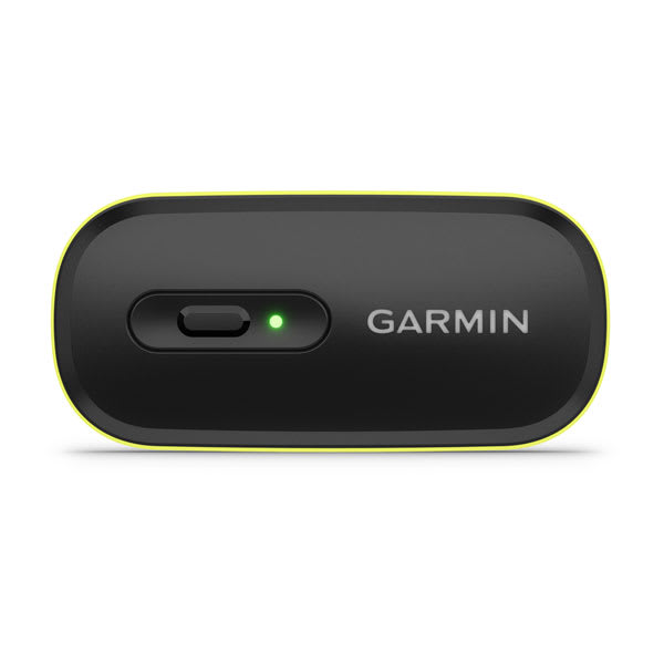 Garmin HRM 600 detail showing the detachable sensor pod unclipped from the strap, the electrode contact pads, the tri-color LED status indicator, and the Garmin proprietary charging port